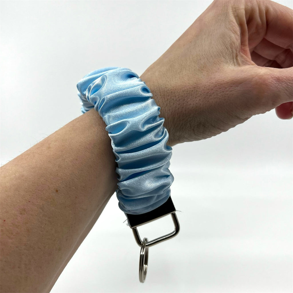 ljusblå scrunchie nyckelring på handleden
